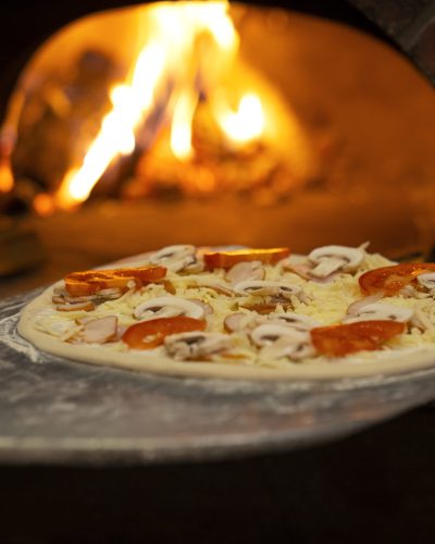 side-view-chef-baking-delicious-pizza (1) (1)